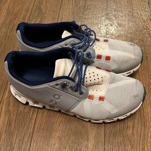 On Running White and Orange Athletic Shoes